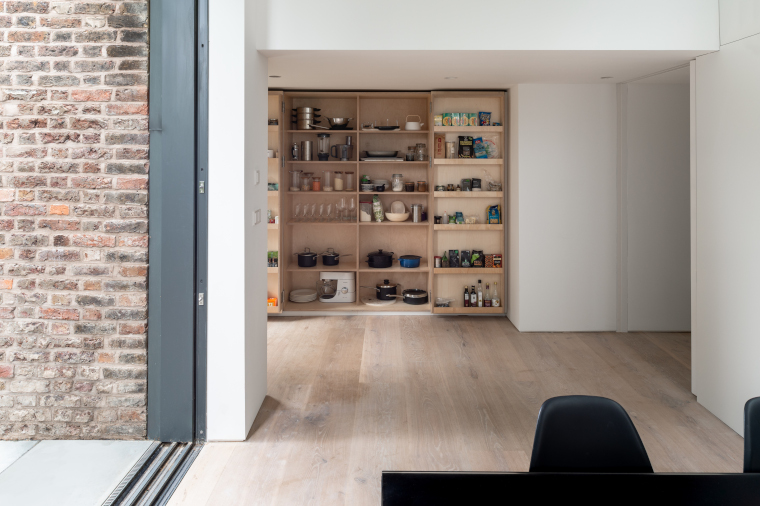 Storage walls conceal kitchen storage in the Passivhaus